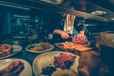 Cropped image of man preparing food in restaurant