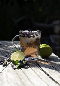 Cold refreshing tea with blueberry, lime and lavender on a hot summer day