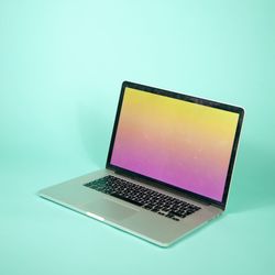 Low angle view of laptop against blue background