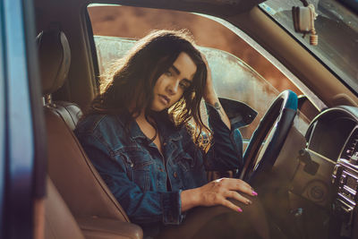 Young woman sitting in car