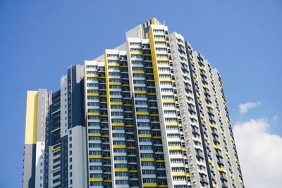 Low angle view of modern building against blue sky