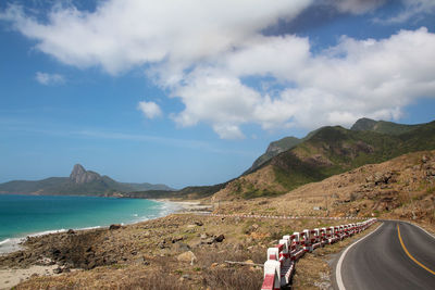 Panoramic view of road by sea against sky