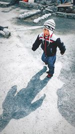 Full length of boy standing in snow