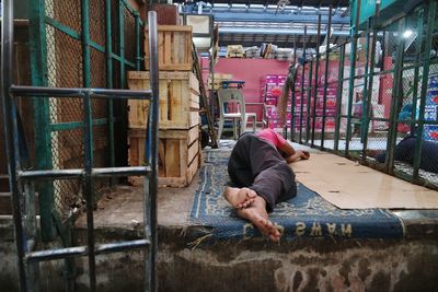 Man sleeping inside workshop