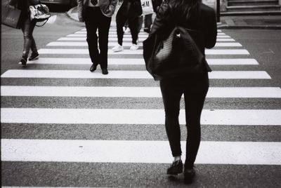 Low section of women walking on street