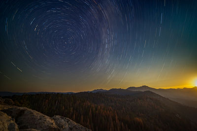 Scenic view of landscape against sky at night