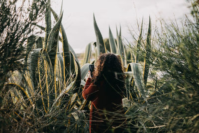 Woman photographing in field