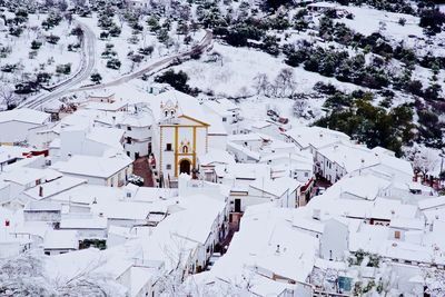 Aerial view of snow over a village.