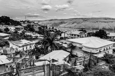 Houses on snowcapped landscape against sky