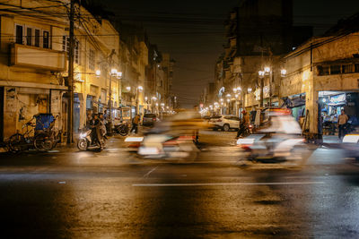 Illuminated city street and buildings at night