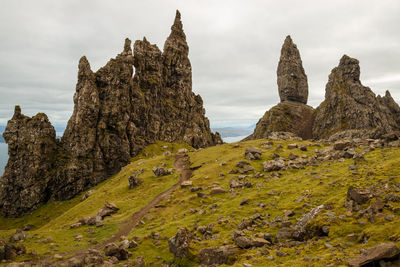 Rock formations on landscape against sky