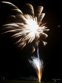 Low angle view of firework display at night