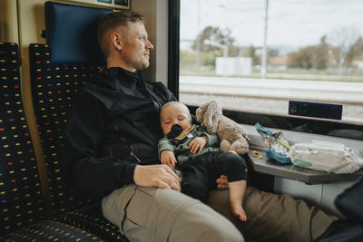 Father traveling with baby by train