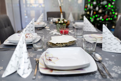 Wafer lying on the hay on the christmas table during christmas eve in poland, visible plates. 