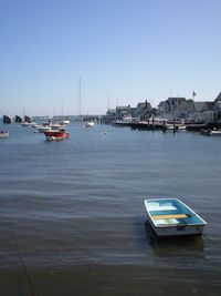 Boats in sea against clear sky