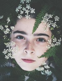 Close-up portrait of woman with red flower