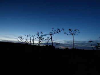 Silhouette landscape against blue sky