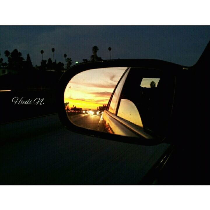 SUNSET REFLECTING IN SIDE-VIEW MIRROR