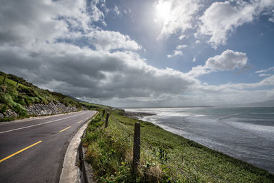 Road by sea against sky