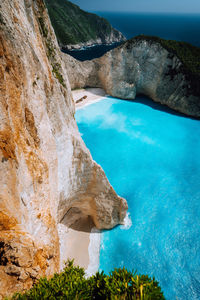 Scenic view of sea by rock formation