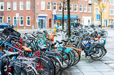 Bicycles parked on street against buildings in city