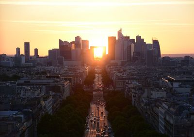 Aerial view of buildings in city during sunset