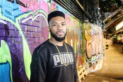 Portrait of man standing in graffiti