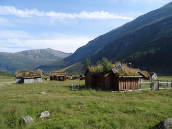 Scenic view of field and mountains against sky