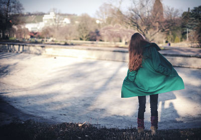 Full length of woman standing on tree trunk