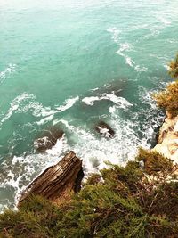 High angle view of rocks on sea shore