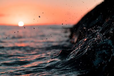 Close-up of water drops on sea against sky