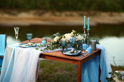 Festive table in blue tones on the banks of the river