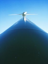 Low angle view of windmill against blue sky