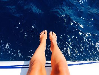 Low section of woman on boat at sea