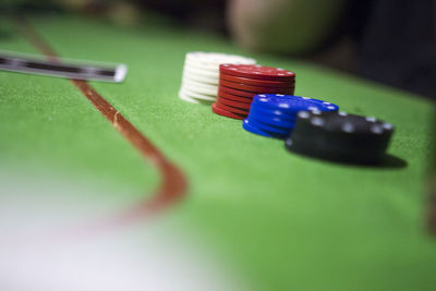 Close-up of gambling chips on table