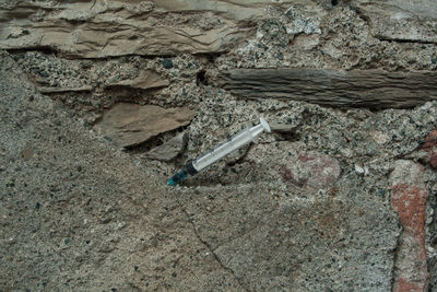 High angle view of cigarette on rock