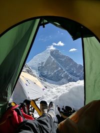 Low section of man sitting in tent during winter