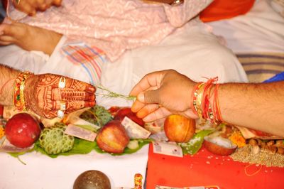 High angle view of hands and vegetables
