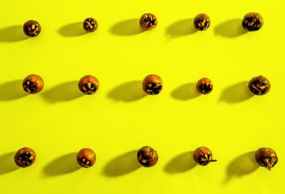 Directly above shot of pills on yellow background