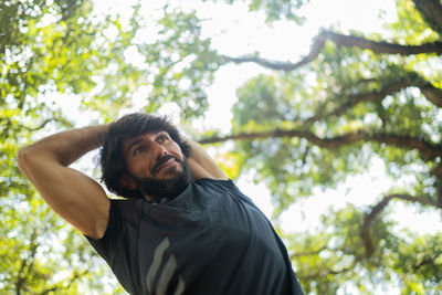 Man stretching before workout at a park outdoors. prepping for workout. feel good, healthy concept.