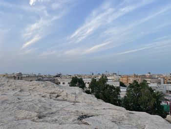 Panoramic view of buildings and trees against sky