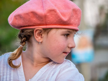 Close-up of thoughtful girl wearing flat cap