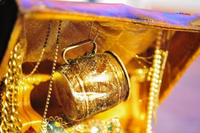 Close-up of gold cup hanging in treasure chest