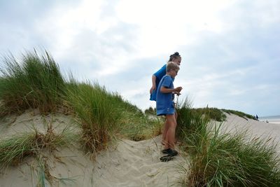 Full length of man on beach against sky