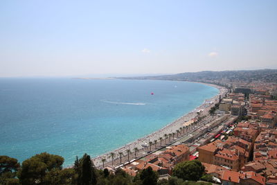 High angle view of sea and cityscape against sky