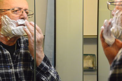 Close-up of man shaving