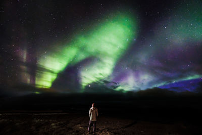 Full length rear view of man standing at night