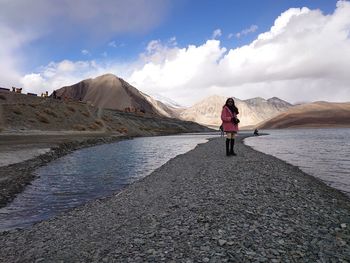 Rear view of woman standing on mountain against sky , sony xperia 1