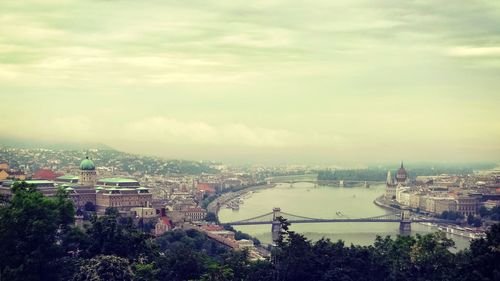 Cityscape against cloudy sky