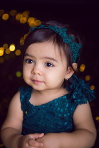 Girl in blue dress in studio with gold sequins and garland